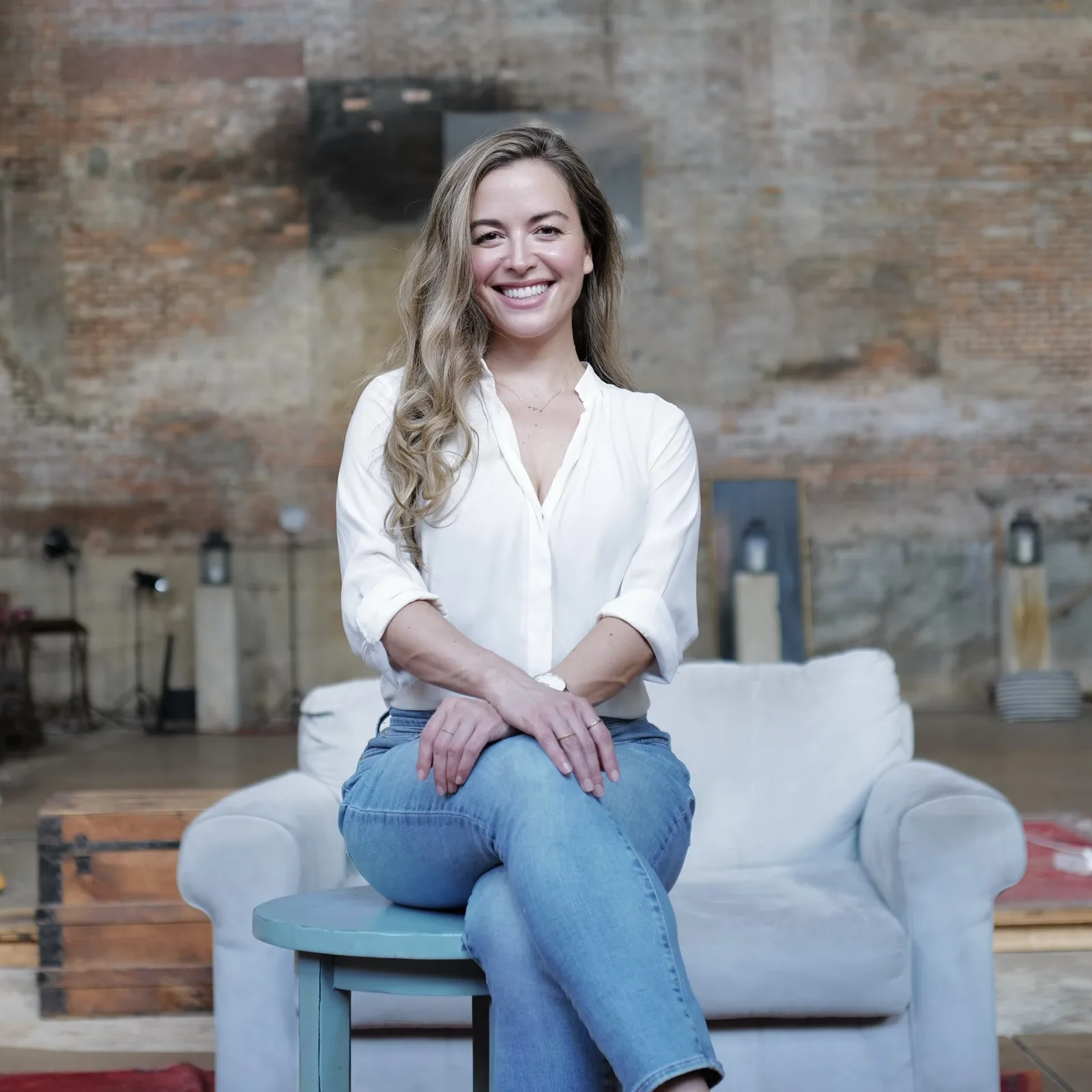 Jessica seated in a sunlit loft