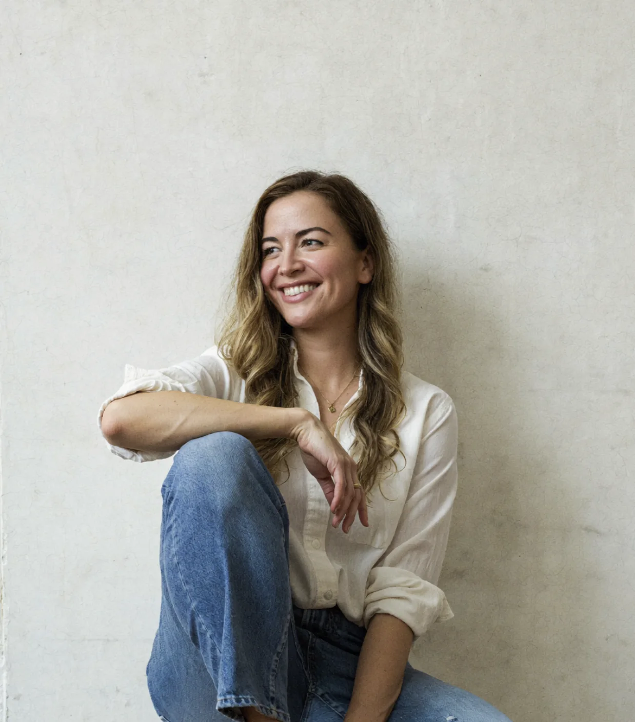 Jessica in a white shirt against a plain wall